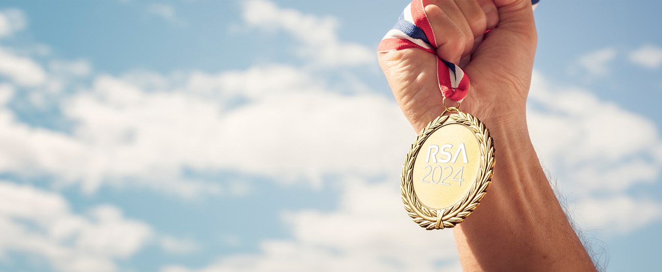Hand holding an RSA 2024 olympic gold metal