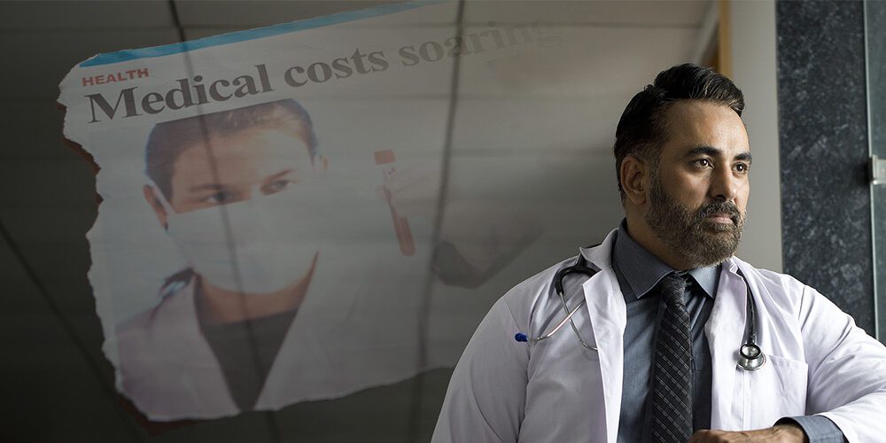 Concerned male doctor thinking about negative news cycle