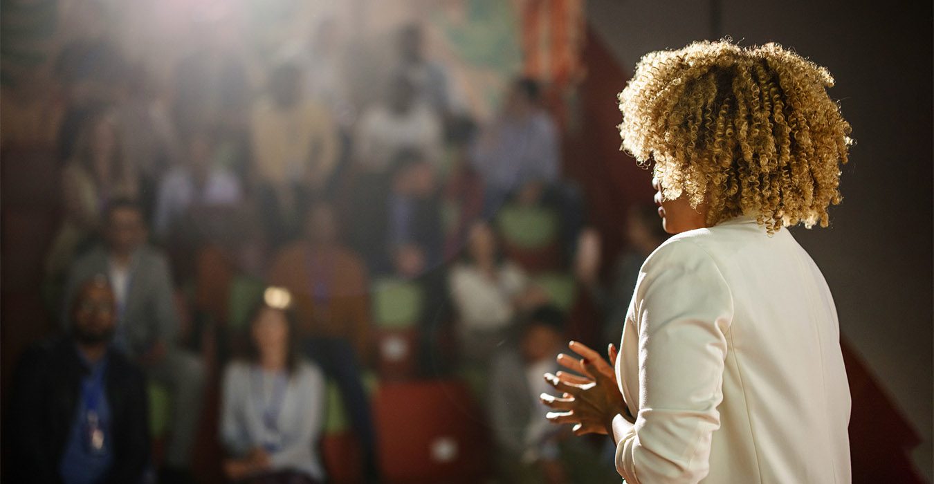 Female thought leader speaking at an event