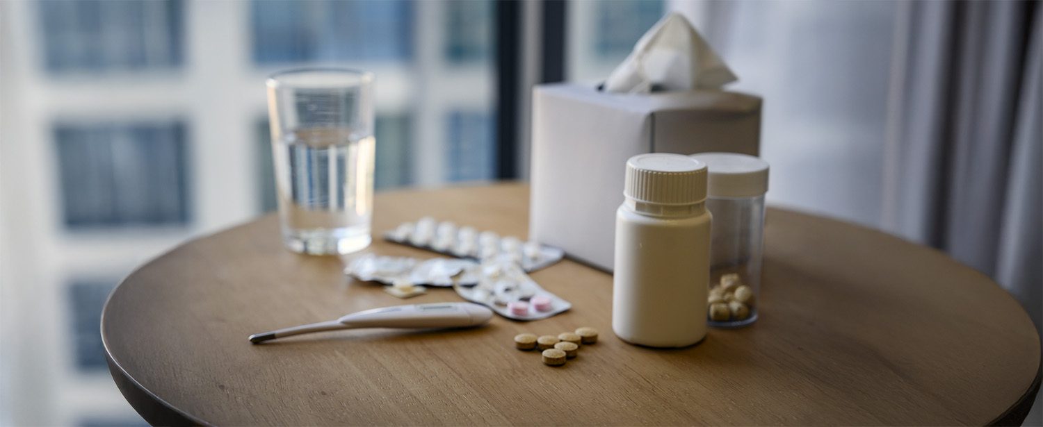 Tissue, medicine, glass of water on the table