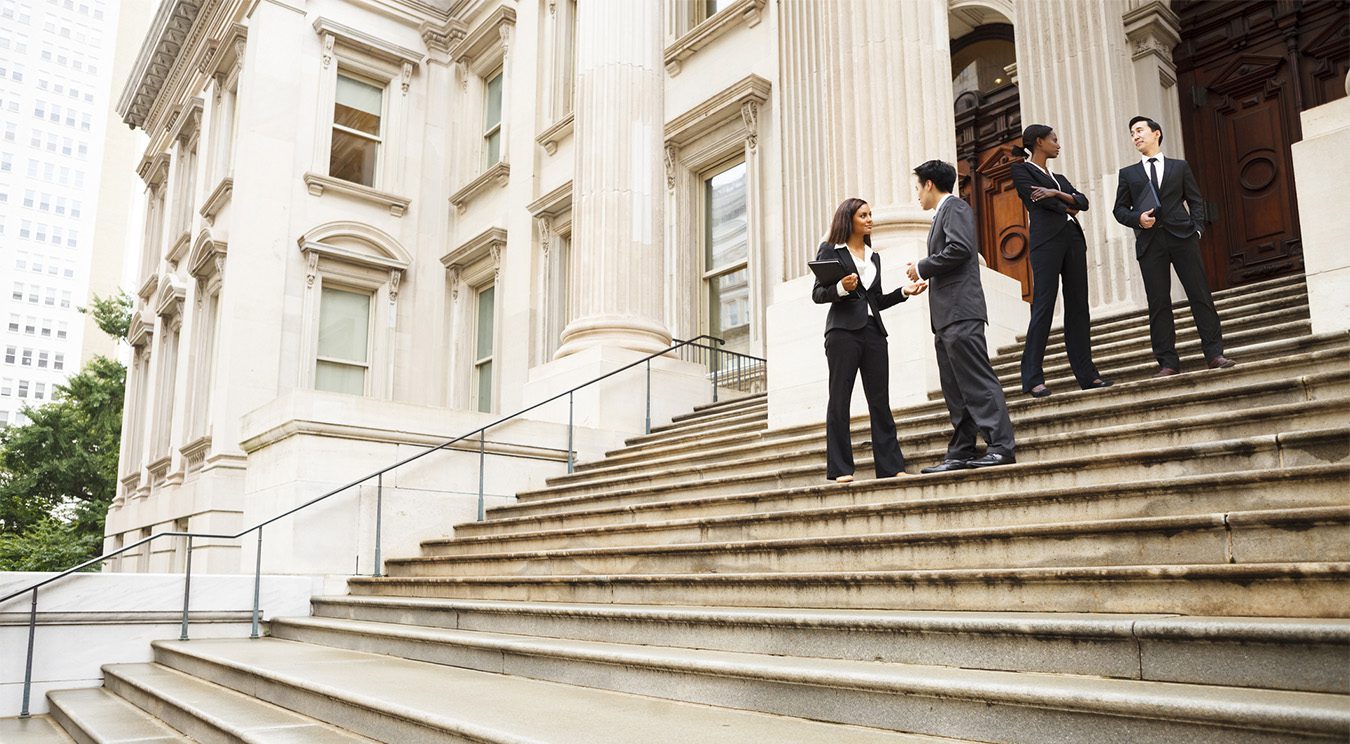 Policy professionals in discussion on steps of the US Capitol.